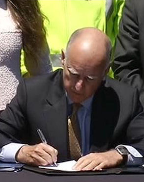 Californian Governor Jerry Brown signing the high speed train bill.
