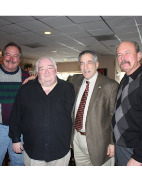 The morbidly obese man is Outfit bookmaker Carl Dote, and he is being hugged by Illinois State Representative Marty Moylan